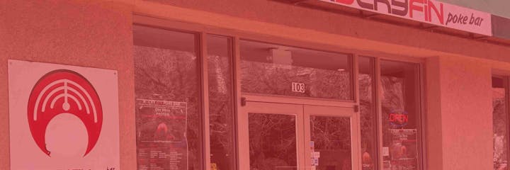 Storefront of Poke Bar with a red logo sign, an "OPEN" sign, and window menu, labeled as suite 103.