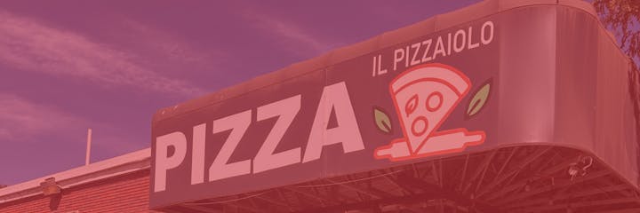 A pizza restaurant sign featuring the word "PIZZA" and "IL PIZZAIOLO," with a pizza slice graphic and green leaves.