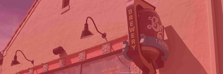 Brewery building exterior with vintage lamps and a "Brewery Taproom" sign.