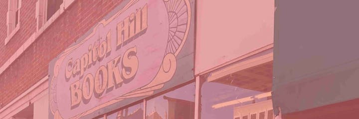 Sign for "Capitol Hill Books" on a brick building.