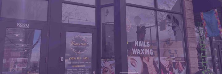 Shopfront with signs for "Suites Nails," nail and waxing services, and business hours; address 2406 E Colfax Ave, Denver, CO.