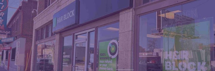 Street view showing H&R Block storefront and lounge sign.