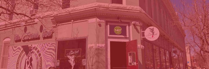 Corner building with "The Corner Beet" sign, located at Ogden 1401 Street. Trees and street visible.