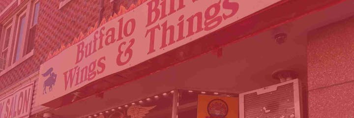 Sign for "Buffalo Bill's Wings & Things" on a building exterior.