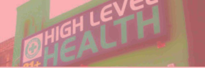 A sign with "High Level Health" and a medical cross symbol.