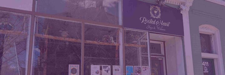 Storefront with "Rooted Heart Yoga & Wellness" sign, posters on windows, and door marked "109".