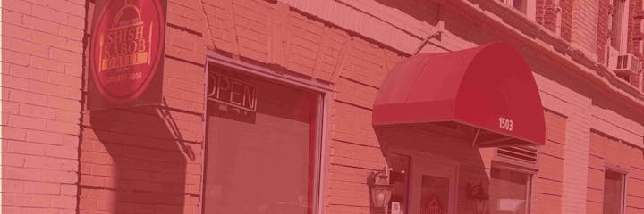 A building with a red awning labeled "1503" and a "Shish Kabob Grill" sign. The building appears to have a brick facade.
