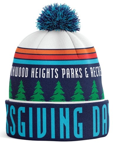 A beanie with a pom-pom, featuring trees and the text "COTTONWOOD HEIGHTS PARKS & REC" and "THANKSGIVING DAY."