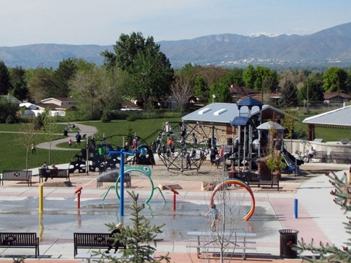 May contain: grass, nature, outdoors, park, plant, outdoor play area, play area, bench, furniture, and person
