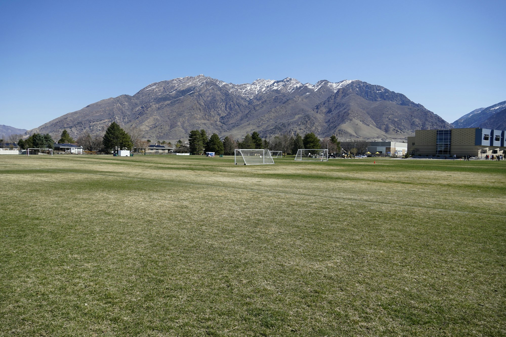 May contain: grass, plant, field, nature, outdoors, mountain, mountain range, grassland, lawn, person, and peak