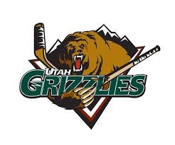 Hockey team logo featuring a bear with mountains, a hockey stick, and the text "Utah Grizzlies."