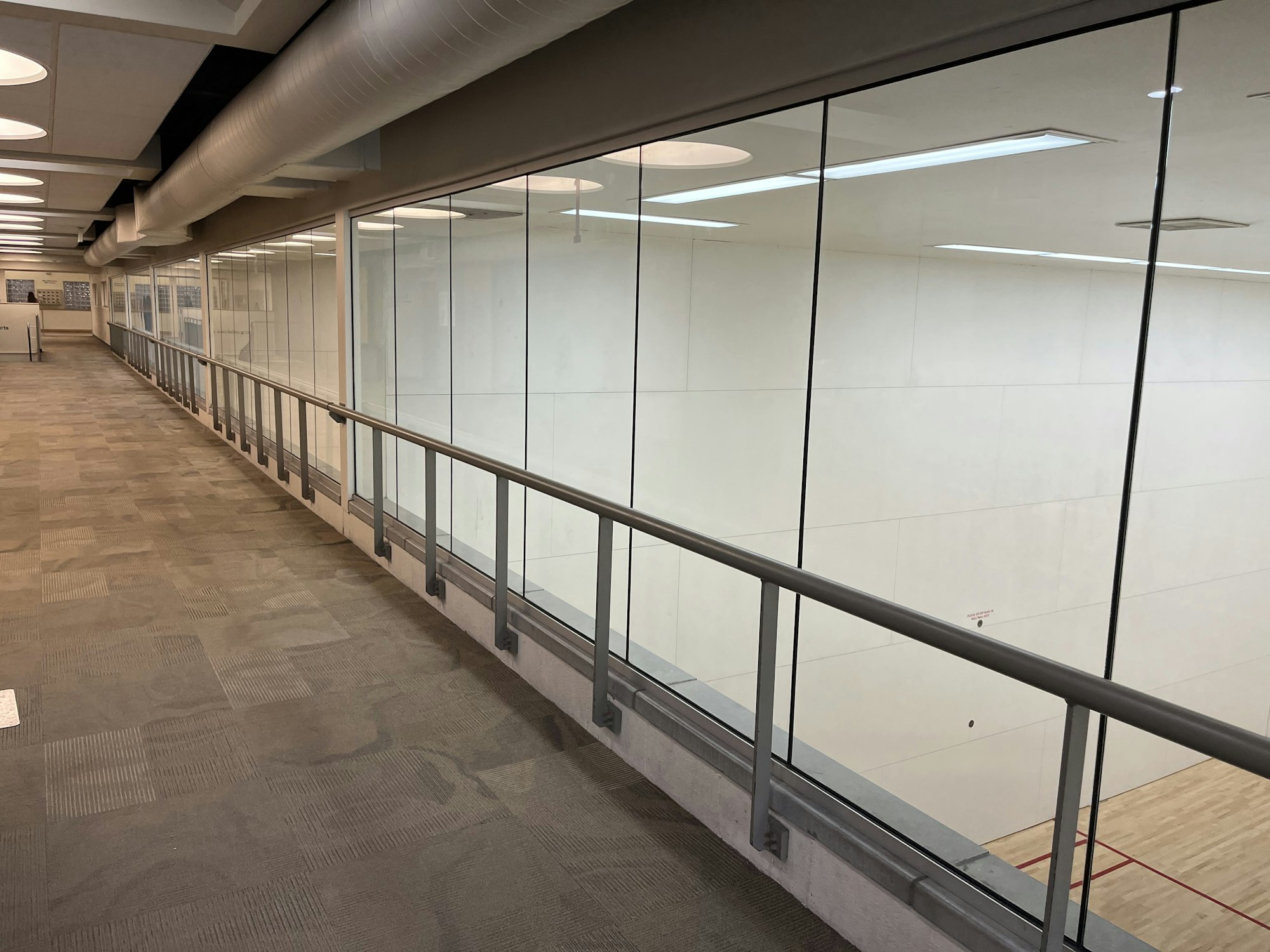 May contain: floor, architecture, building, corridor, indoors, handrail, interior design, and person