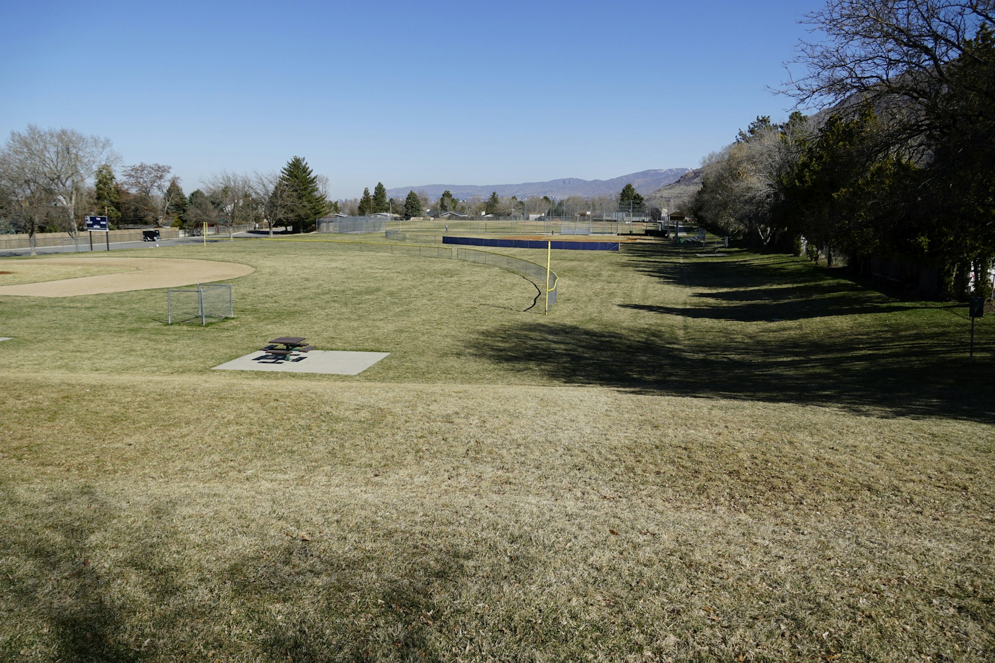May contain: field, nature, outdoors, grassland, grass, plant, golf, golf course, sport, car, transportation, and vehicle