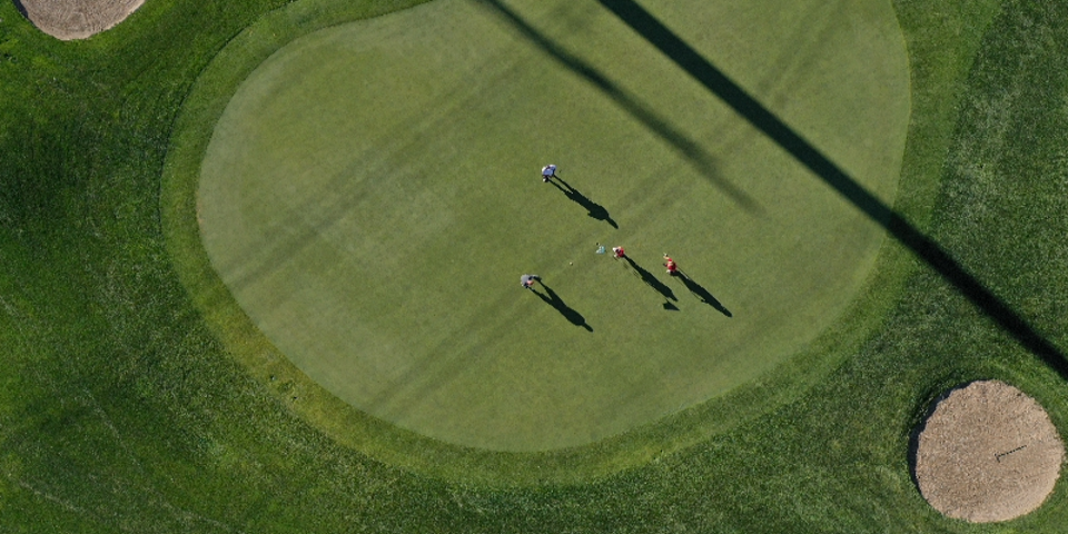 May contain: field, outdoors, nature, golf, golf course, and sport
