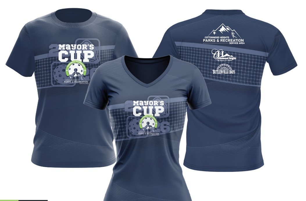 The image shows a blue t-shirt for the "Mayor's Cup" event, featuring designs and logos for Cottonwood Heights Parks & Recreation.