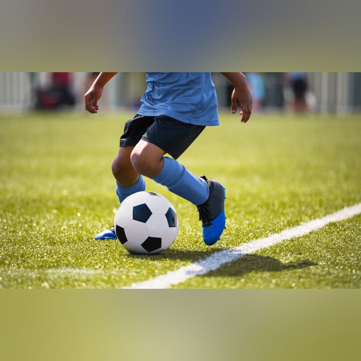 May contain: ball, football, soccer, soccer ball, sport, sphere, boy, child, male, person, clothing, footwear, shoe, and shorts