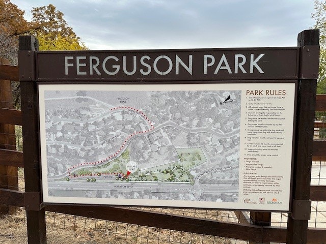 A sign titled "FERGUSON PARK" with a map and park rules.