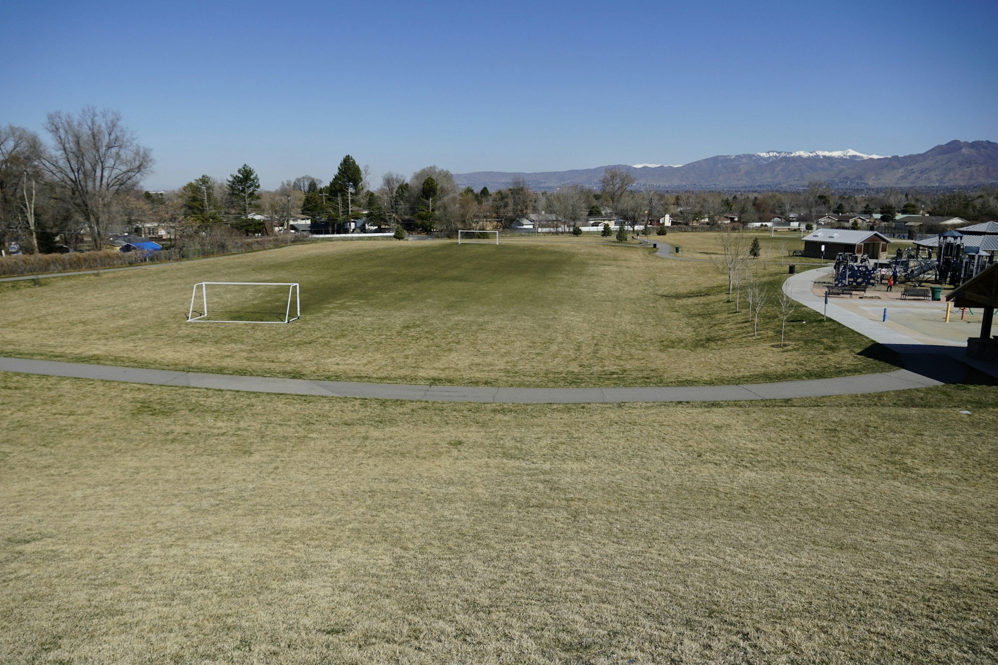 May contain: field, grassland, nature, outdoors, grass, plant, bench, furniture, airport, person, and airfield