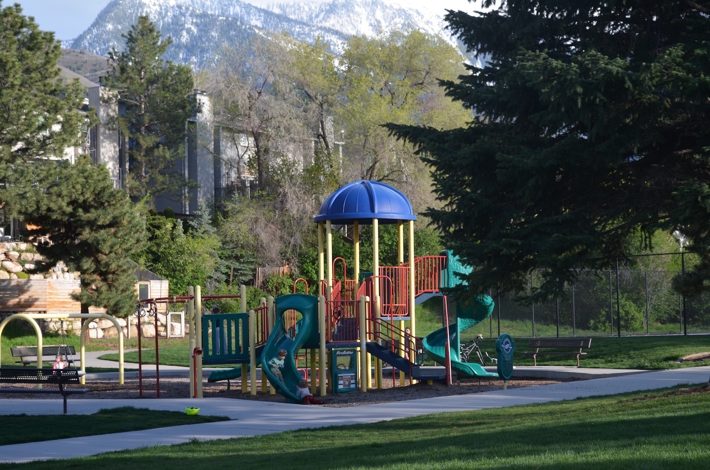 May contain: outdoor play area, outdoors, play area, grass, plant, nature, park, bench, furniture, and person