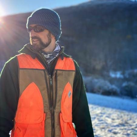 May contain: clothing, coat, jacket, photography, vest, cap, hat, lifejacket, face, head, person, portrait, adult, male, and man