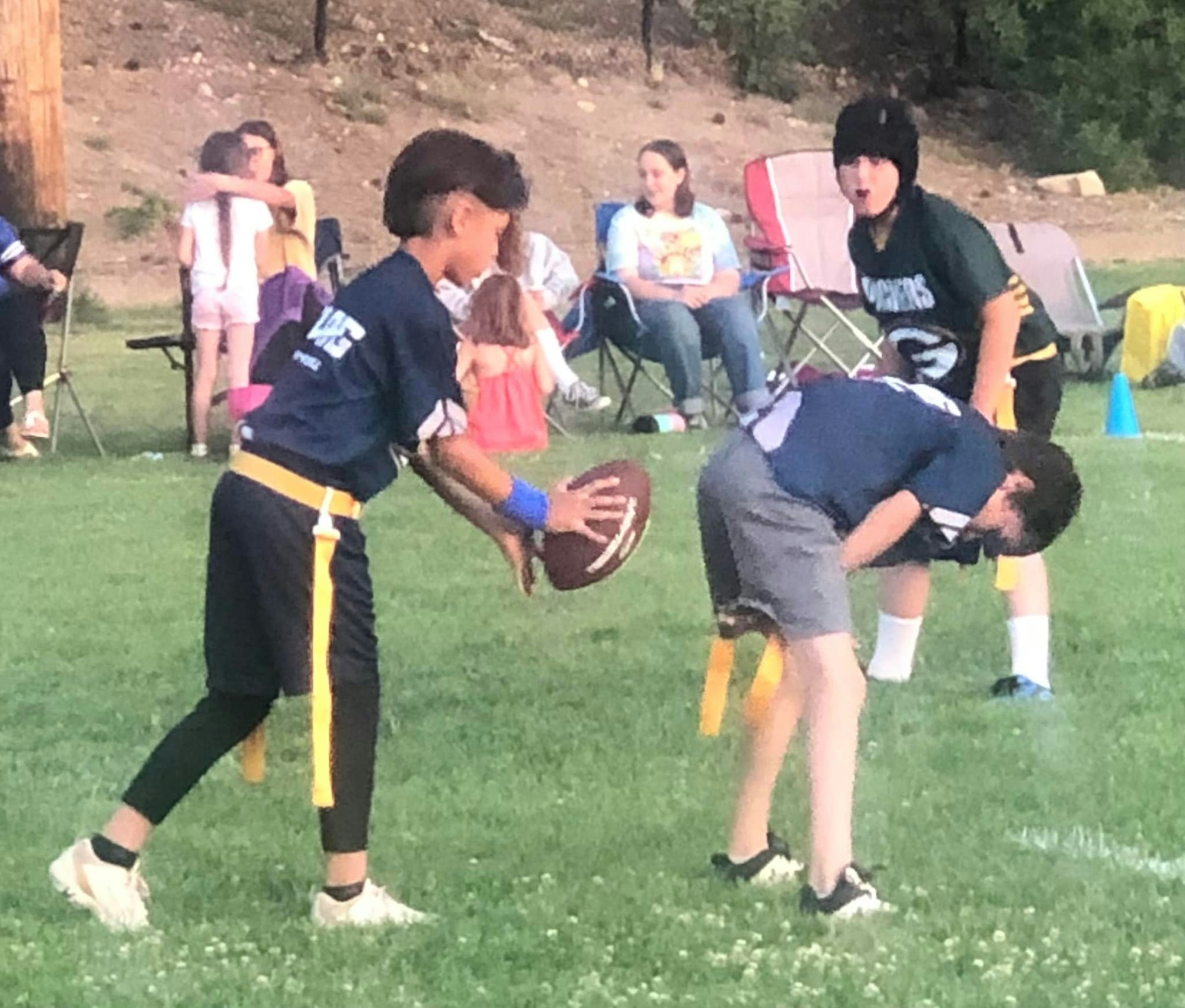 May contain: ball, rugby, rugby ball, sport, people, person, field, grass, plant, american football, football, and playing american football