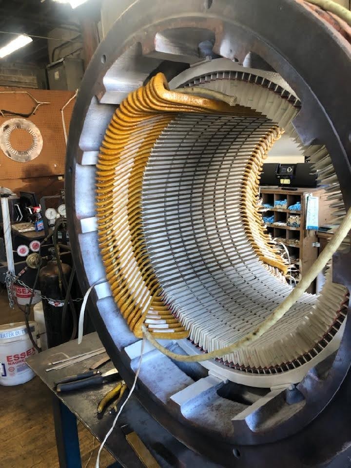 May contain: rotor, coil, spiral, machine, factory, building, architecture, and wheel