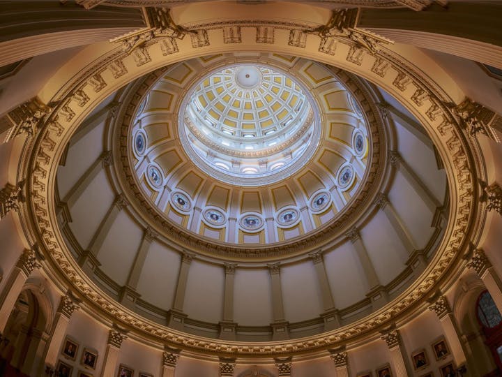 Elegant dome interior with intricate design, lit windows, and ornate details.