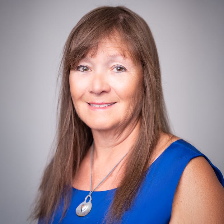 Board Member Joan Brown smiling at the camera.