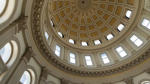Dome interior with intricate design and windows, likely from a historic building or capitol.