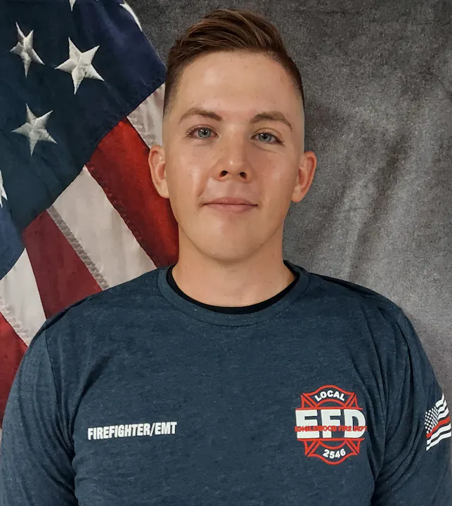 The image features a person in a firefighter/EMT uniform with an American flag in the background.