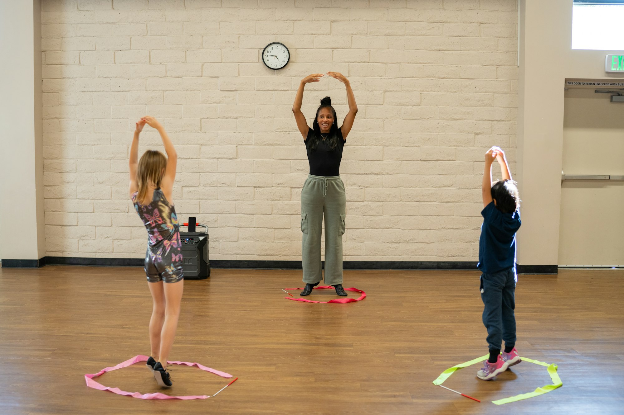 Kids following instructor doing stretches