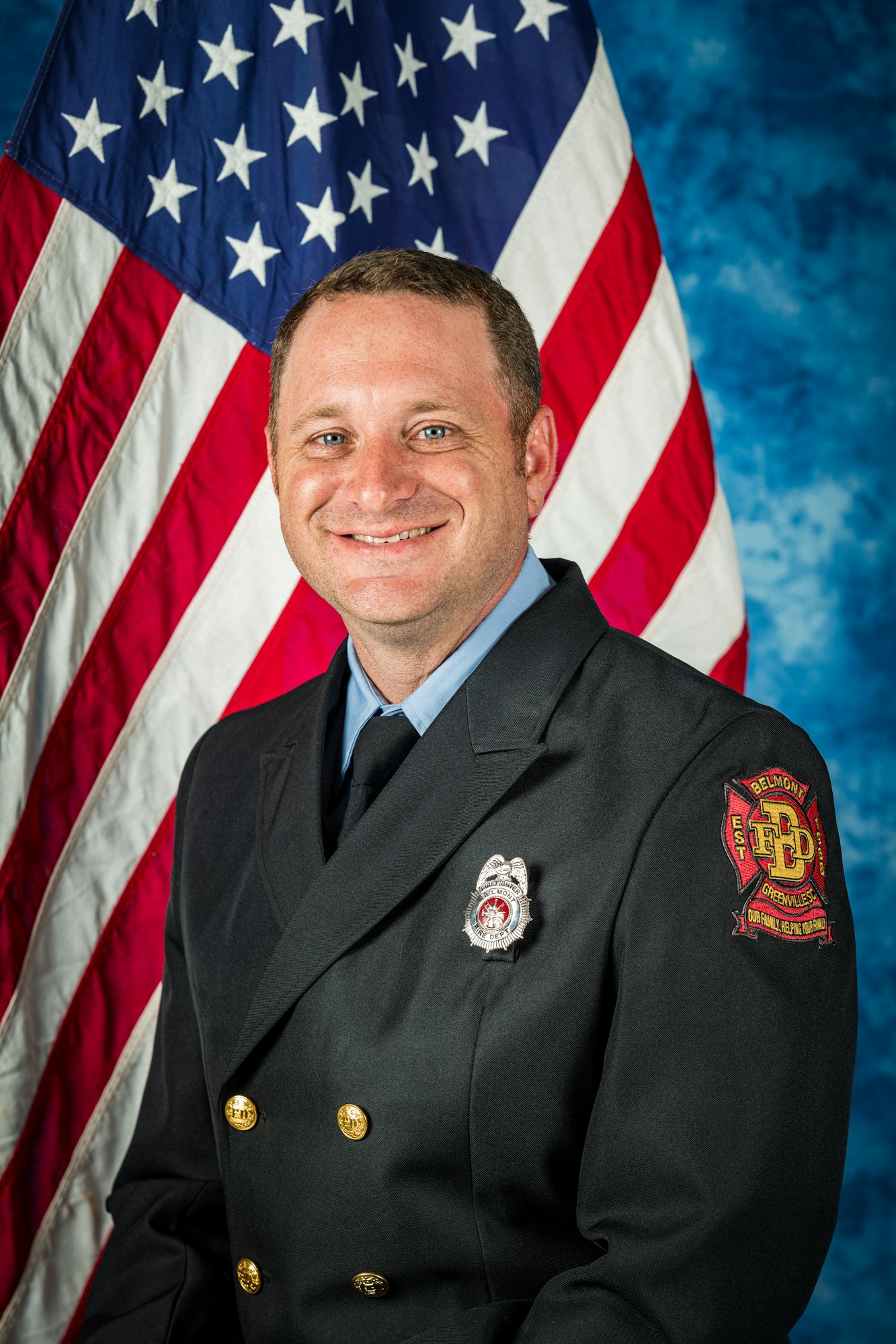 FF/EMT Adam Epstein 2024 Photo in front of an American flag.