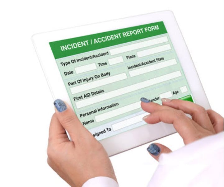 Hands holding a tablet displaying an "Incident/Accident Report Form," including fields for details about the event.