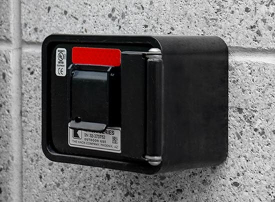 A black card reader mounted on a gray wall, likely for access control.