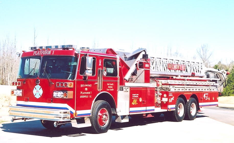 Red fire truck with ladder, marked "BELMONT FD," parked on a sunny day.
