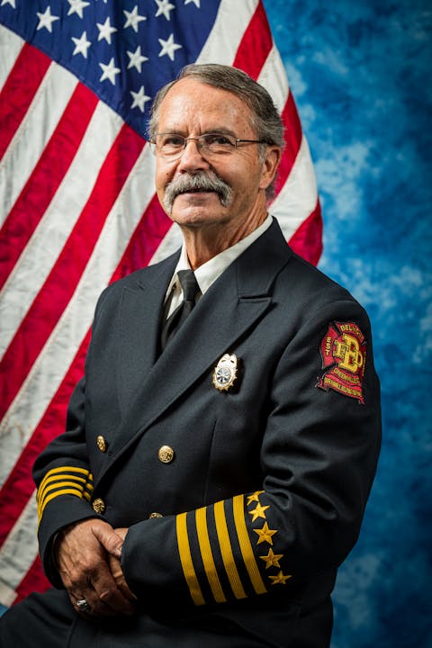 Asst. Chief Marty Reynolds 2024 Photo in front of a U.S. flag.