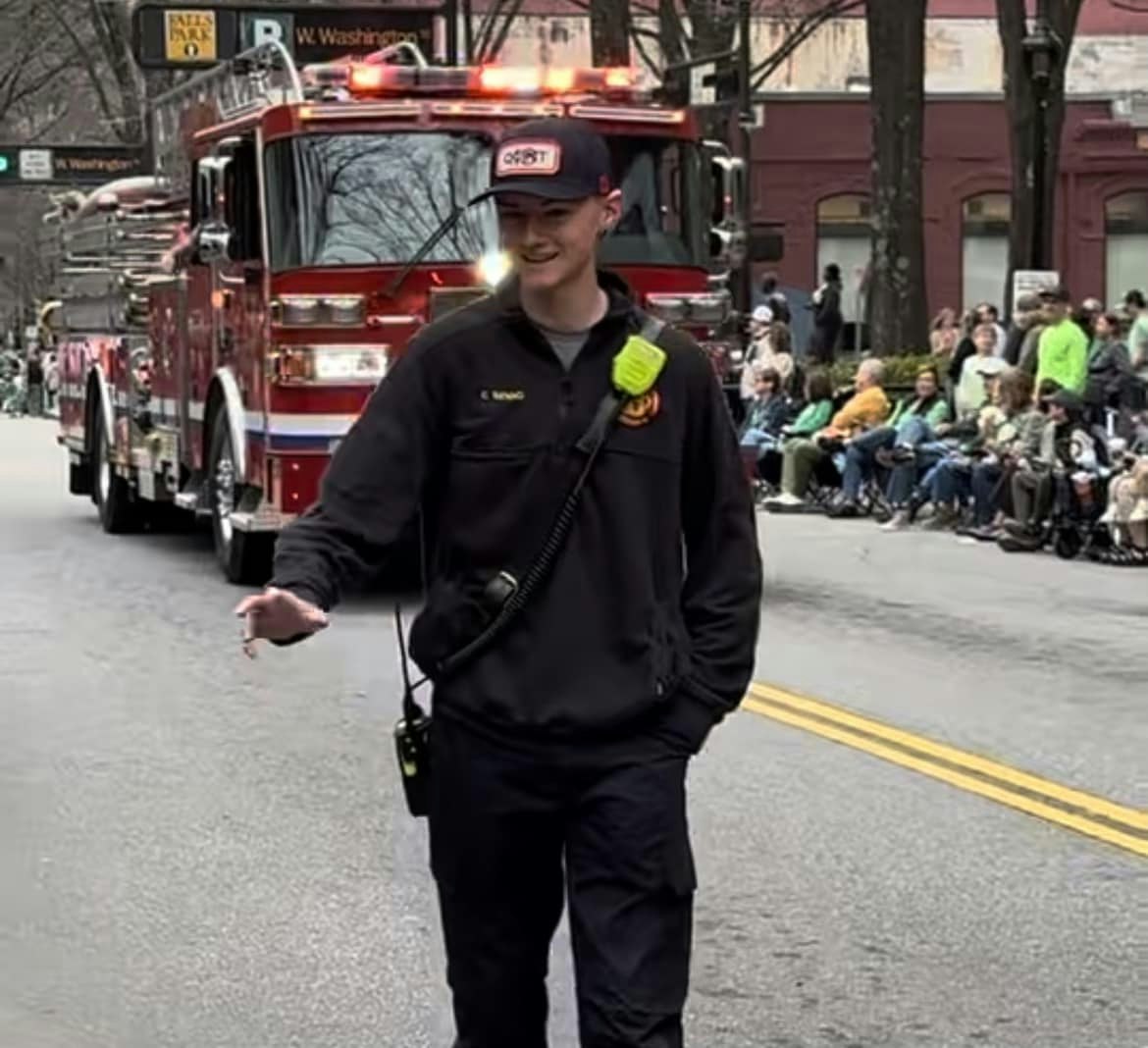 Caden Senno walking with Quint 13 in Parade