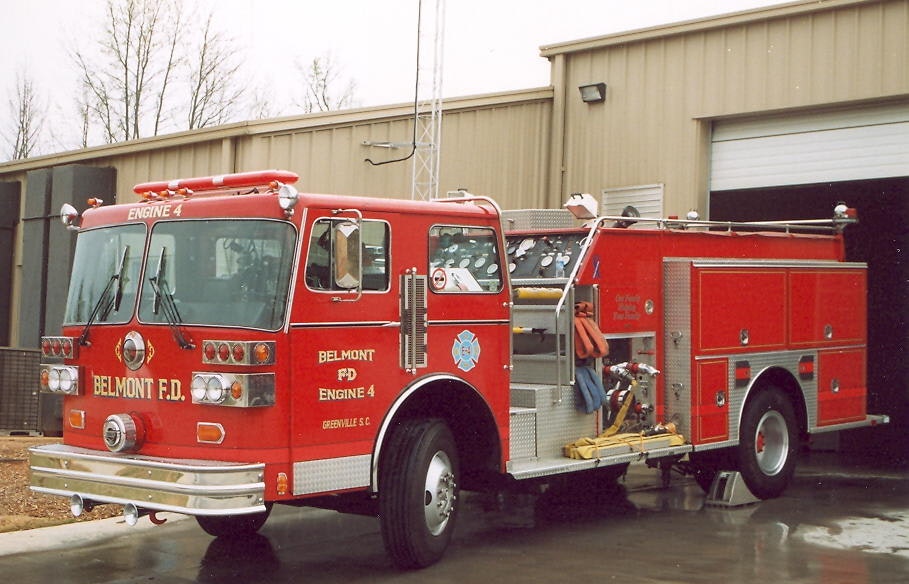 A red fire truck labeled "BELMONT F.D. ENGINE 4" parked outside a building.