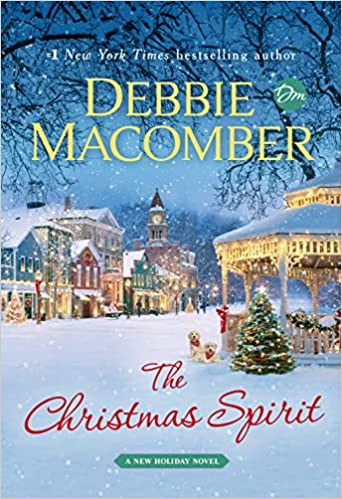 A snowy Christmas scene on a book cover titled "The Christmas Spirit" by Debbie Macomber.