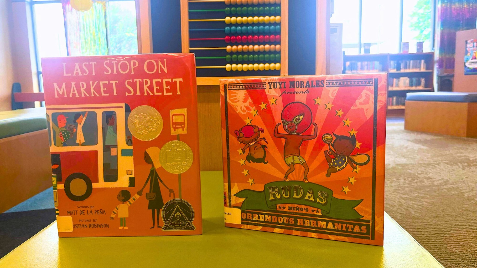 Two children's books on display in a library setting.