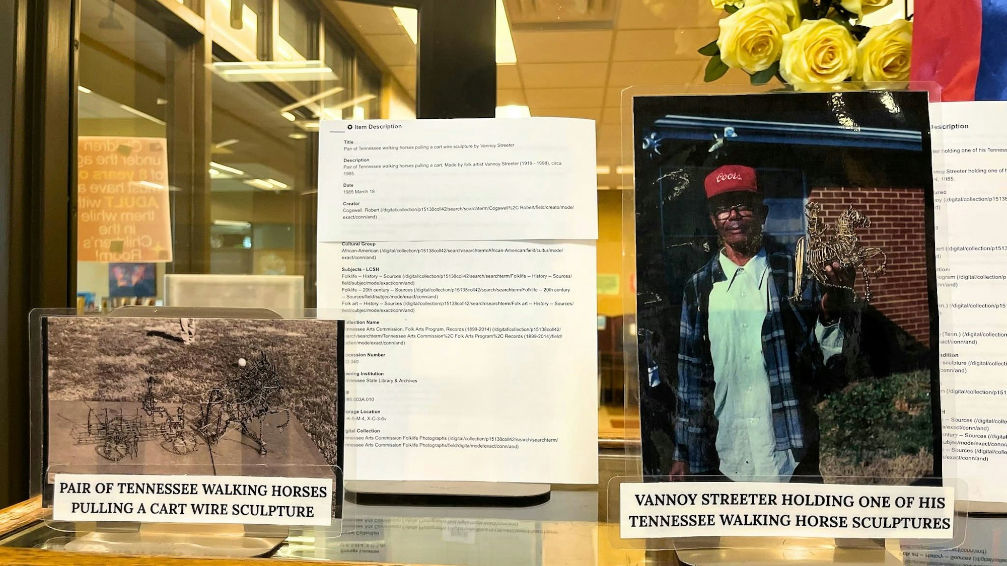 The image shows a display with a wire sculpture of Tennessee walking horses and a photo of artist Vannoy Streeter with his sculpture.