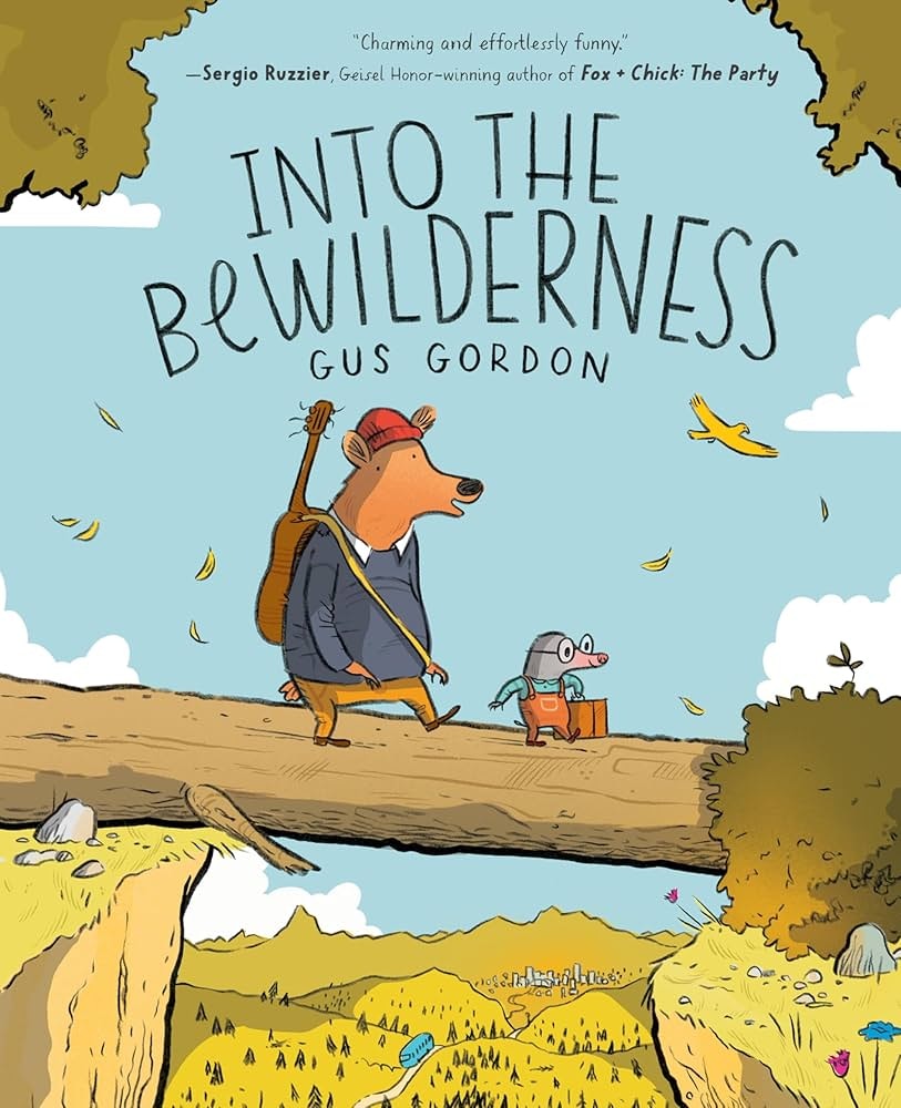 A bear and a mouse wearing clothes cross a log over a valley. The cover reads "Into the Wilderness" by Gus Gordon.
