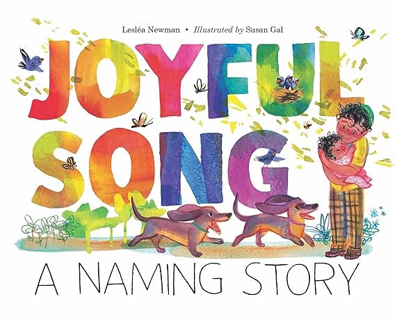 Colorful book cover titled "JOYFUL SONG," featuring a woman holding a child with two dogs, surrounded by nature and music notes.