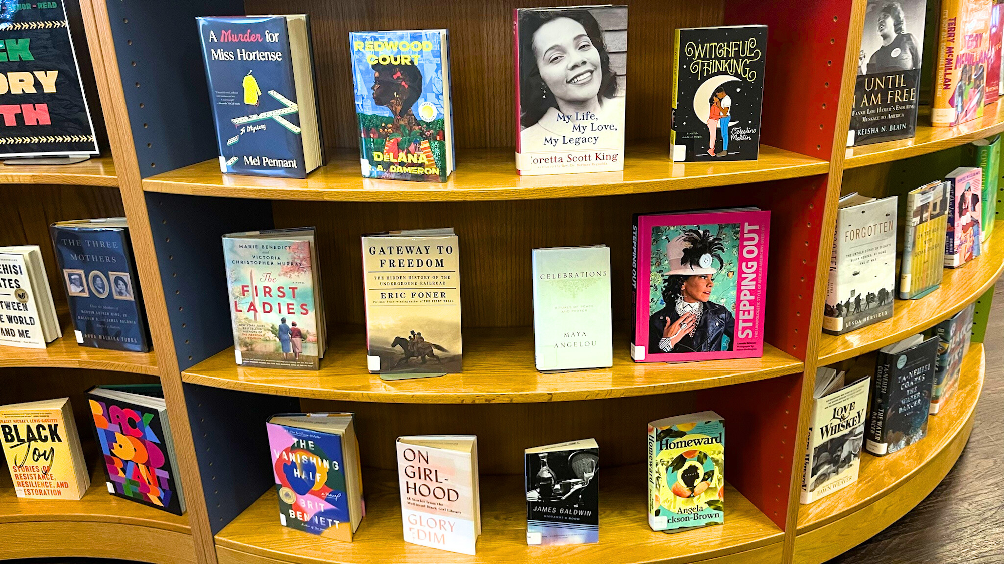A bookshelf filled with diverse books, showcasing titles related to history, culture, and personal narratives.