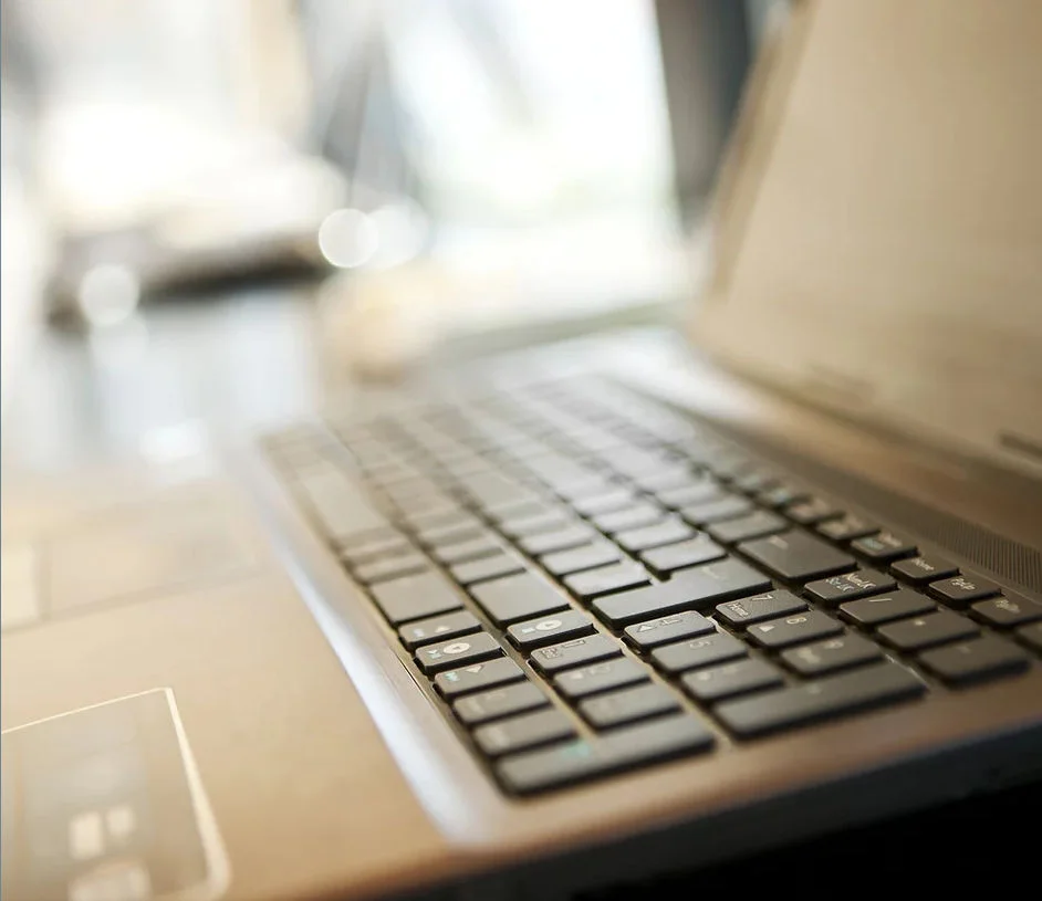Close-up of a laptop keyboard with a blurred background.