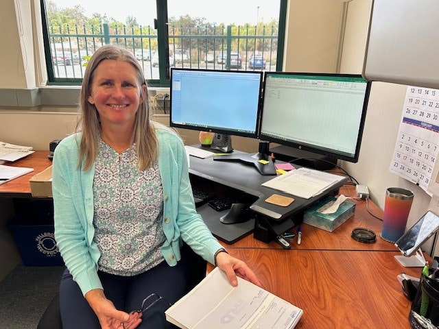 Employee of the year Annalece sits at her desk in the accounting department.