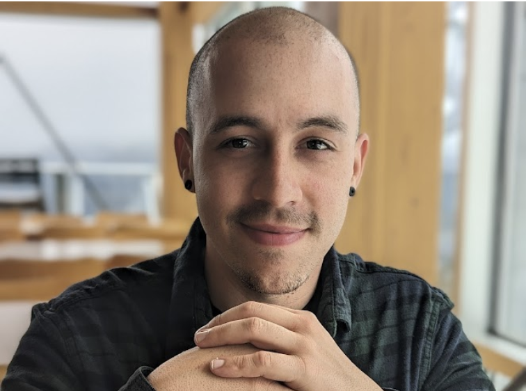 Shawn Jordison indoors, resting chin on hands.