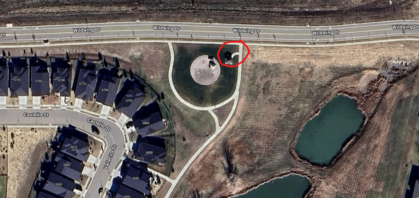 The image shows an aerial view of a residential area with houses, a park, and two ponds, along Wildwing Drive.