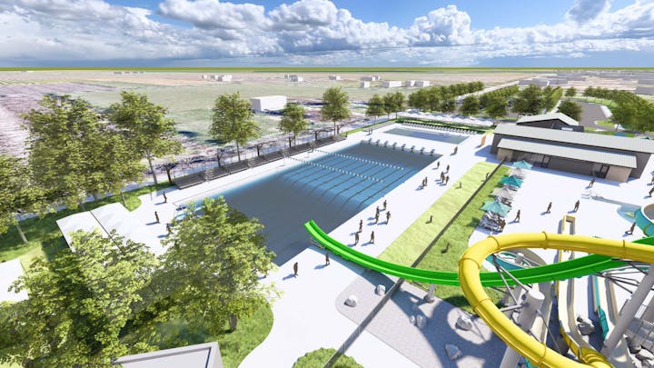An outdoor water park with pools, slides, and trees under a blue sky.
