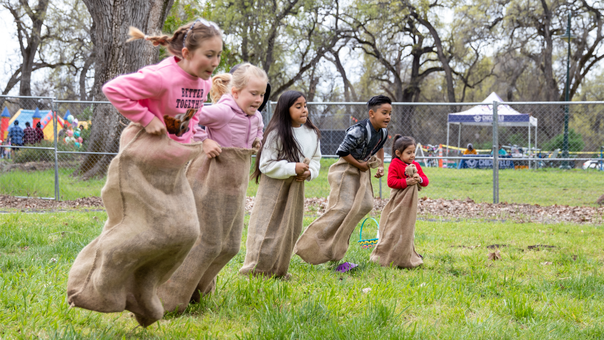 May contain: bag, person, tent, child, female, girl, grass, plant, car, transportation, vehicle, and sack